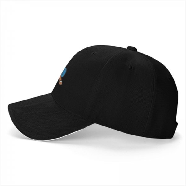 Black baseball cap with Cookie Monster covering a gingerbread man’s eyes