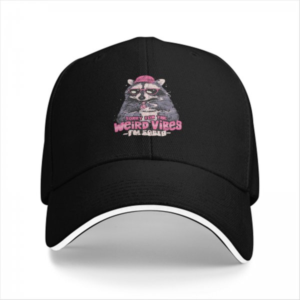 Black baseball cap with raccoon graphic and 'Sorry for the weird vibes I'm sober' text