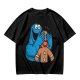Olive T-shirt with Cookie Monster covering gingerbread man’s eyes