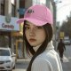 Black baseball cap with walking silhouettes against a moon backdrop