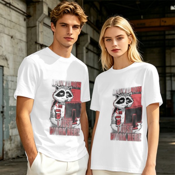 Olive graphic t-shirt with a tired raccoon office worker and 'I Just Work Here' text
