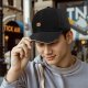 Black baseball cap with small angry pot character graphic