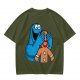 Olive T-shirt with Cookie Monster covering gingerbread man’s eyes