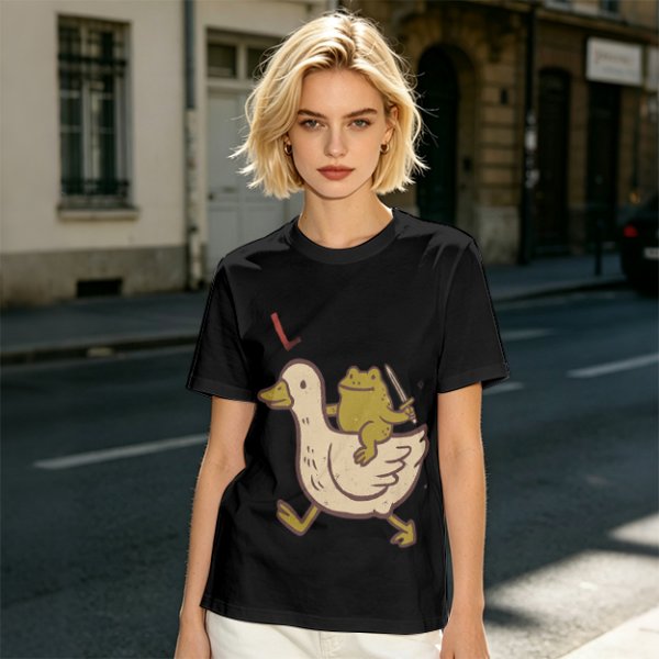 Olive T-Shirt Featuring Frog Riding Duck Holding Knife