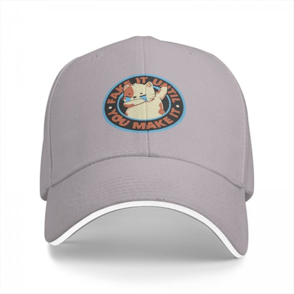 Black baseball cap with crying cat graphic and fake it until you make it text