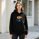 Black hoodie with yin-yang nature landscape graphic featuring bird and wave
