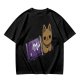 Olive T-shirt with a cartoon cat emerging from a purple chocolate wrapper print