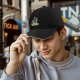 Black baseball cap with colorful cat graphic and Evil Girls text