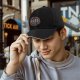 Black baseball cap with dancing skeletons and 'Dance Your Problems Away' text