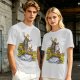 Olive T-shirt with fantasy characters balancing on a log over a stream