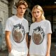 Olive T-shirt with a terrified gingerbread man and flying birds graphic