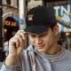Black baseball cap with grumpy owl holding coffee and 'COFFEE' text