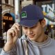 Black baseball cap with green 'DISOBEY' portrait graphic