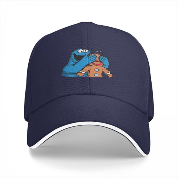 Black baseball cap with Cookie Monster covering a gingerbread man’s eyes