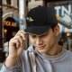 Black baseball cap with cartoon burning character and worried companion graphic