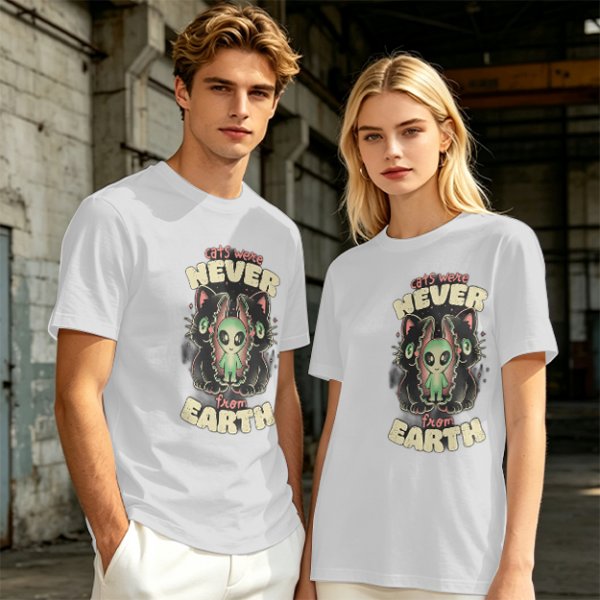 Olive green graphic t-shirt with 'cats were never from earth' alien and cat print