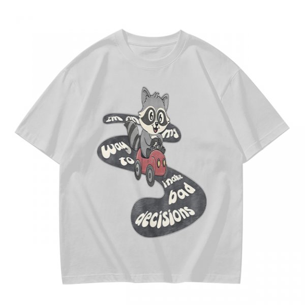 Olive graphic tee with raccoon driving car and 'Way to make bad decisions' text