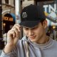 Black baseball cap with embracing skeletons and red heart print