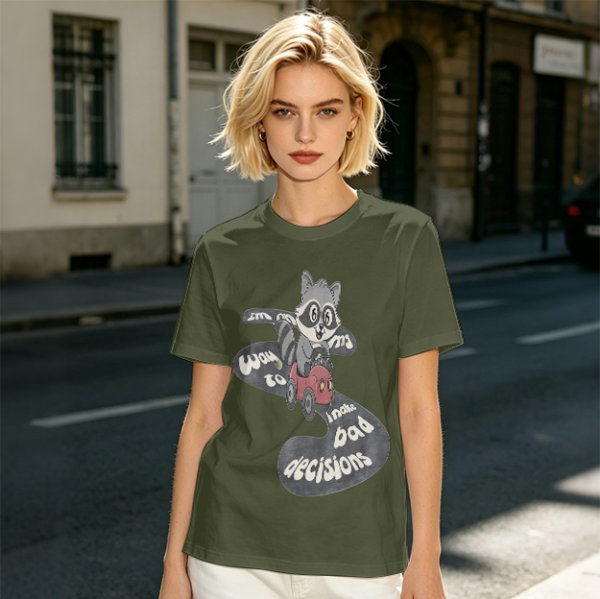 Olive graphic tee with raccoon driving car and 'Way to make bad decisions' text