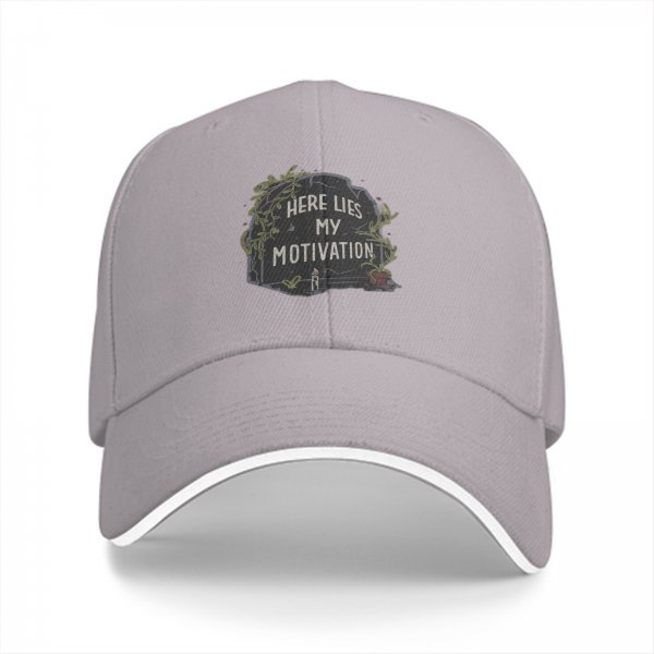 Black baseball cap with 'Here Lies My Motivation' tombstone graphic