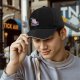 Black baseball cap with anxious unicorn and magical text design