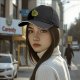 Black baseball cap with cute green cat holding orange yarn ball