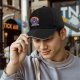 Black baseball cap with cheerful purple cat rainbow and Life is a Meowsical text