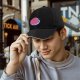 Black baseball cap with cartoon poop graphic and text print