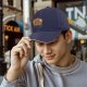 Black baseball cap with cute capybara graphic and playful text