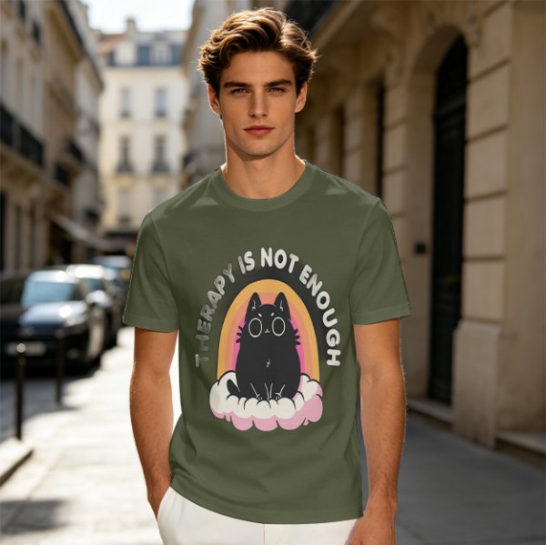 Olive graphic tee with black cat, rainbow, and 'Therapy Is Not Enough' text