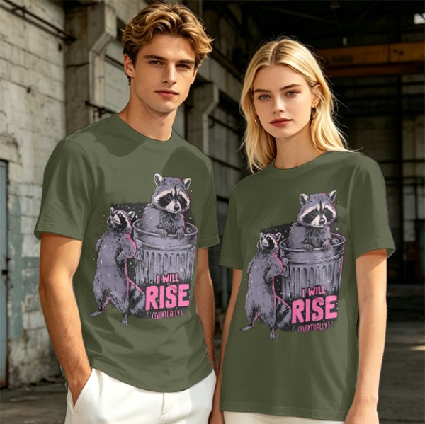 Olive graphic t-shirt with raccoons and 'I Will Rise Eventually' text