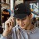 Black baseball cap with sloth graphic and 'Just Do It Later' text