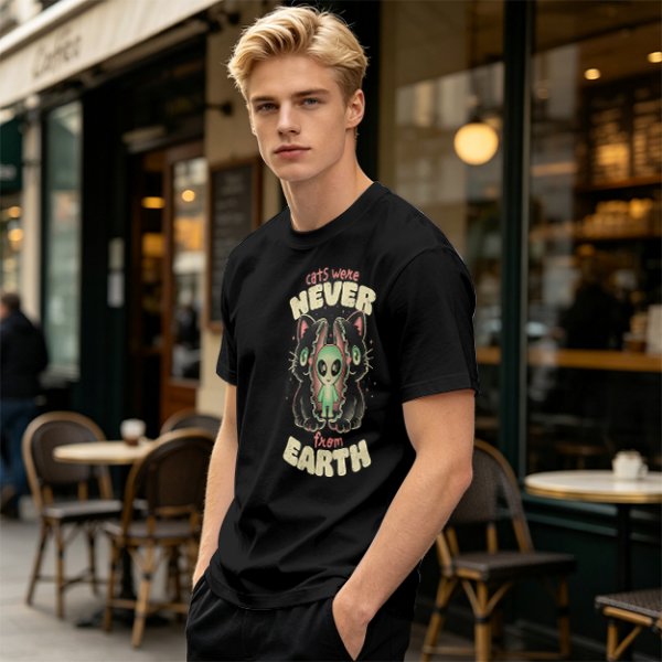 Olive green graphic t-shirt with 'cats were never from earth' alien and cat print