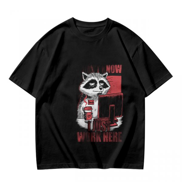 Olive graphic t-shirt with a tired raccoon office worker and 'I Just Work Here' text