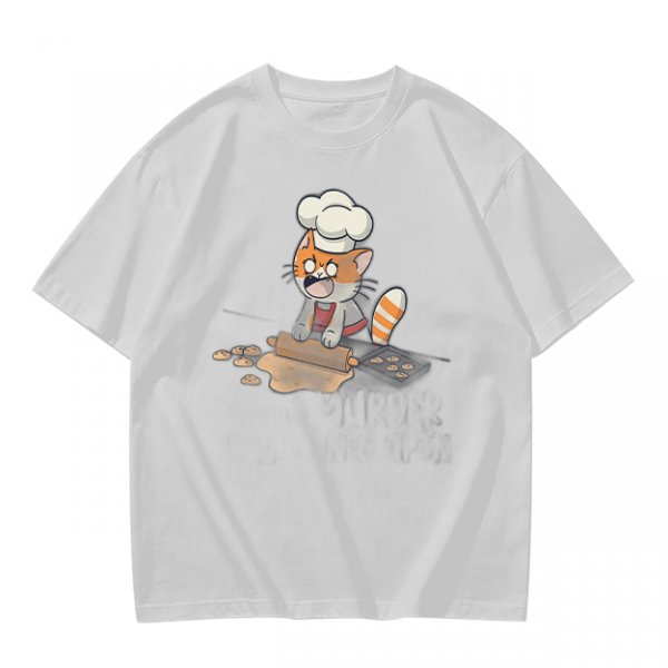Olive T-shirt with a stressed cartoon cat baking cookies