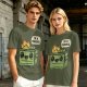 Olive green t-shirt with a cartoon dumpster on fire saying I'm a phoenix