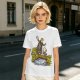 Olive T-shirt with fantasy characters balancing on a log over a stream