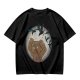 Olive T-shirt with a terrified gingerbread man and flying birds graphic