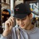 Black baseball cap with 'All of Us Are Red' text and red graphic